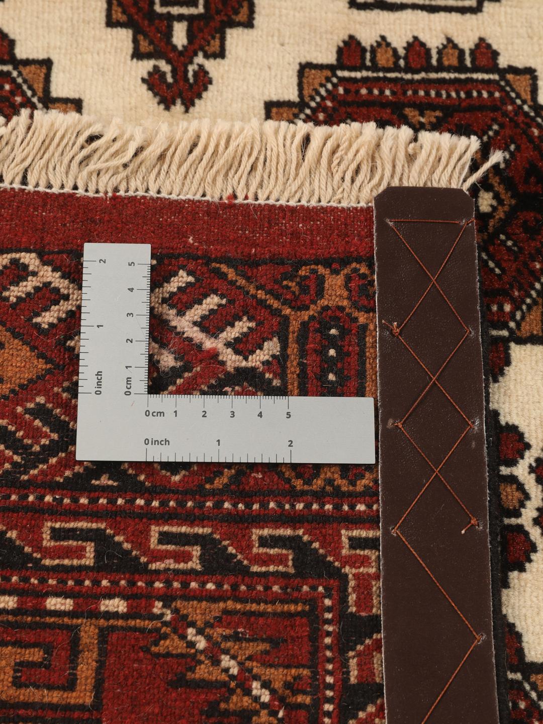 Hand-knotted Turkaman Wool rug with geometric patterns in red and beige from the Middle East.