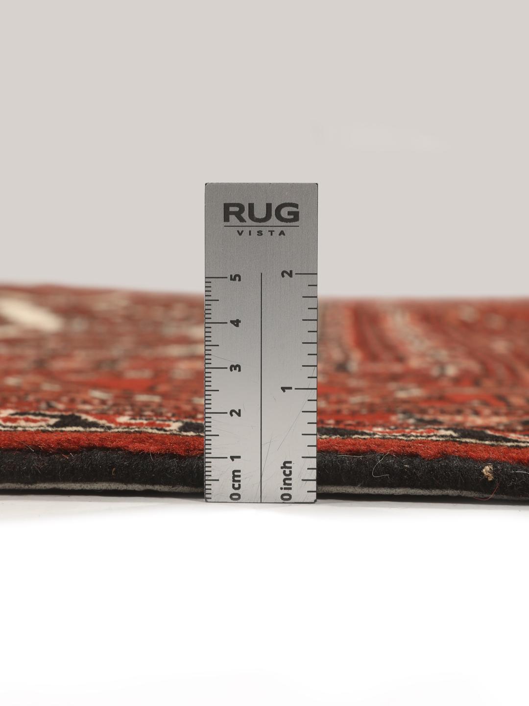 A hand-knotted, one-of-a-kind Turkaman rug with a red field and traditional geometric motifs.
