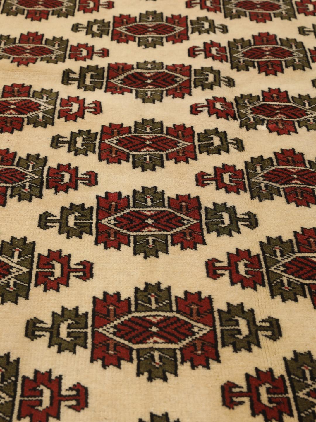 Hand-knotted Turkaman Wool rug from the Middle East in red and cream
