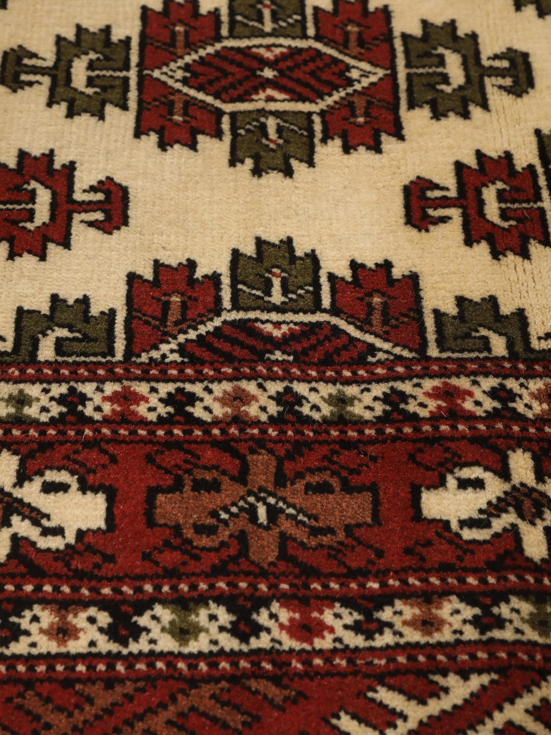 Hand-knotted Turkaman Wool rug from the Middle East in red and cream