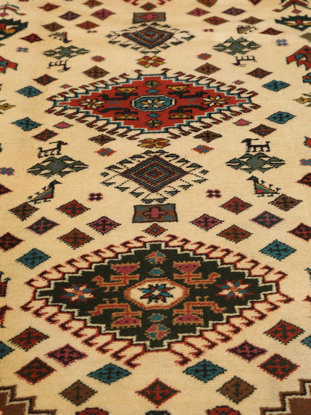 Hand-knotted Turkaman rug from the Middle East featuring a red and beige geometric pattern