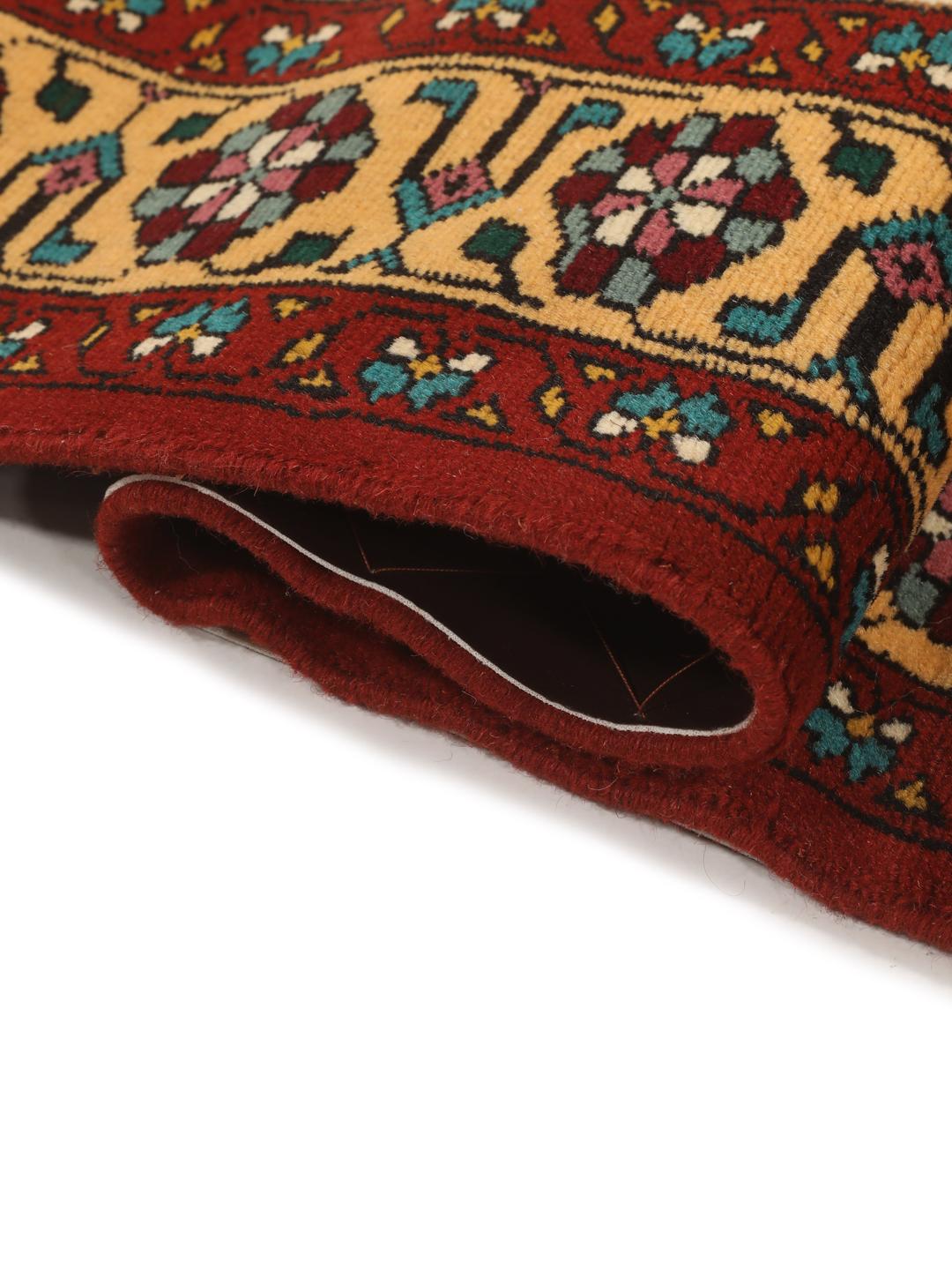 Hand-knotted Turkaman rug from the Middle East featuring a red and beige geometric pattern