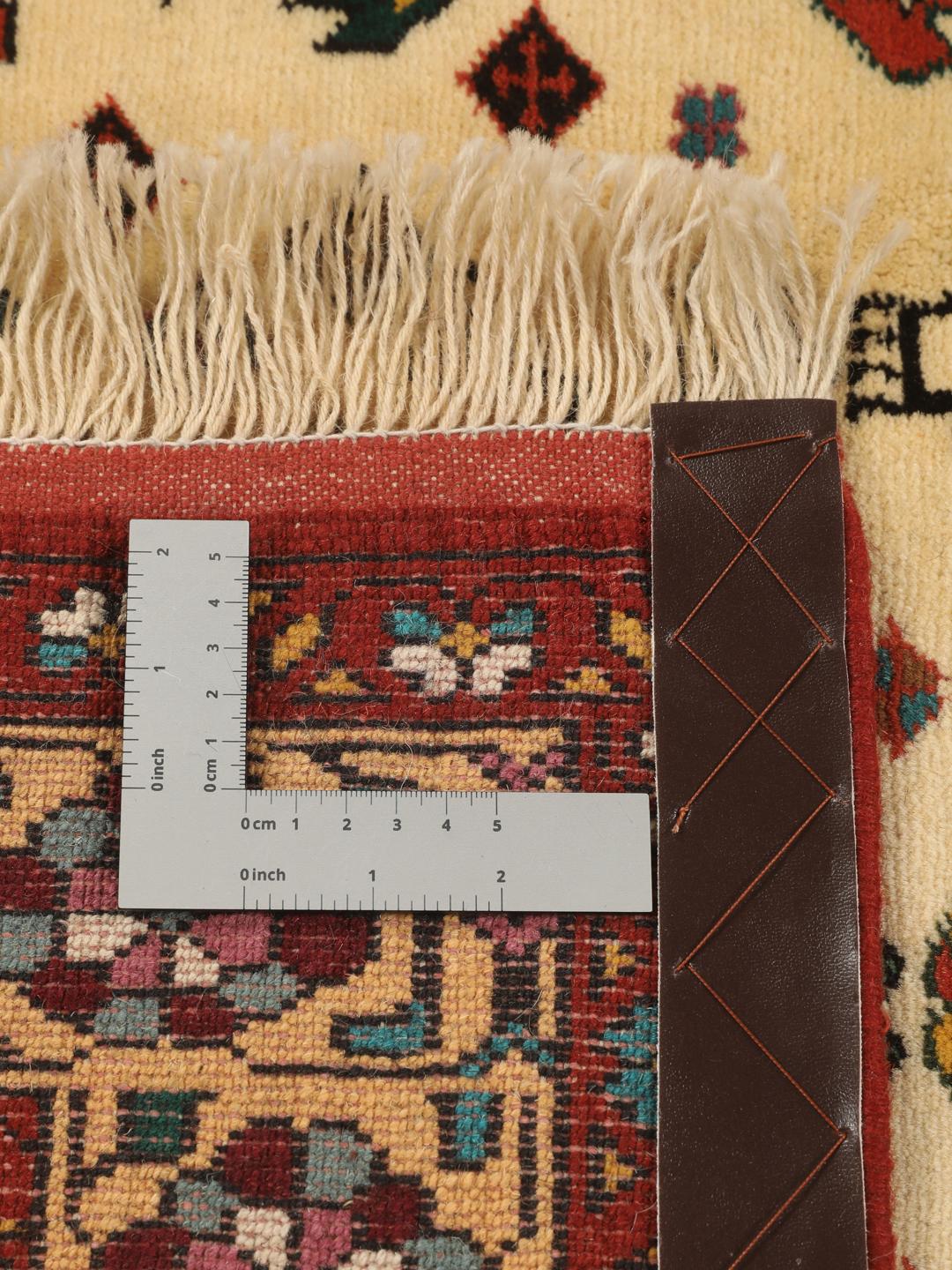Hand-knotted Turkaman rug from the Middle East featuring a red and beige geometric pattern
