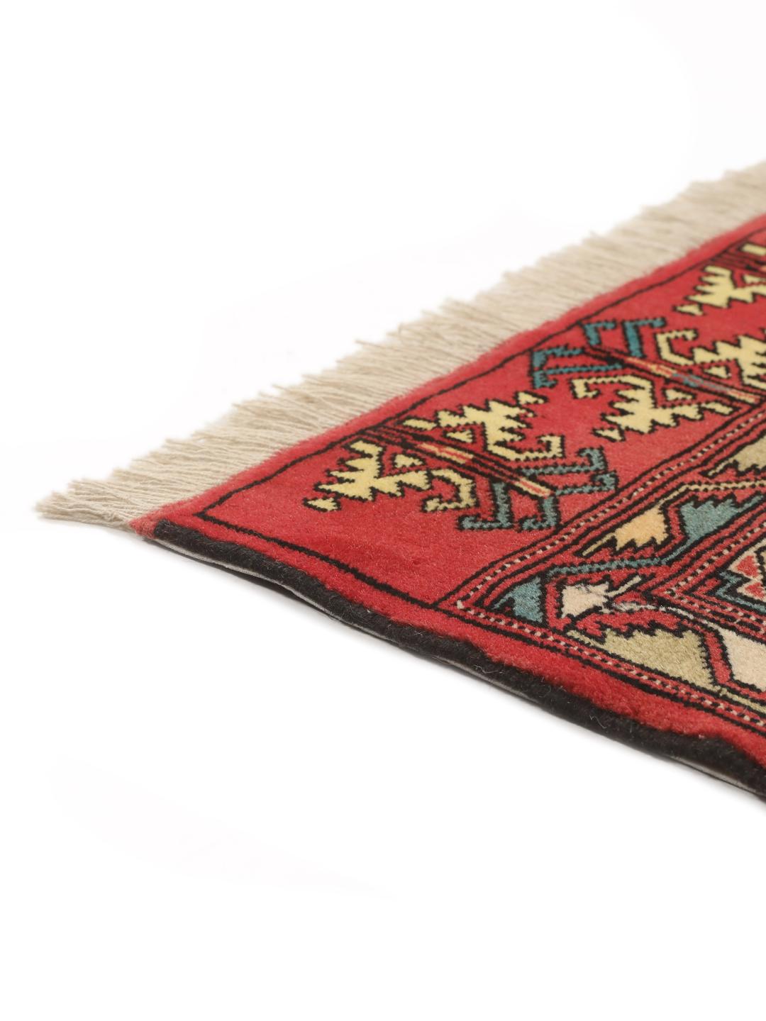 Hand-knotted Turkaman rug from the Middle East in vibrant red and geometric patterns
