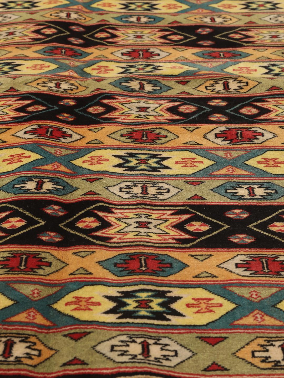 Hand-knotted Turkaman rug from the Middle East in vibrant red and geometric patterns