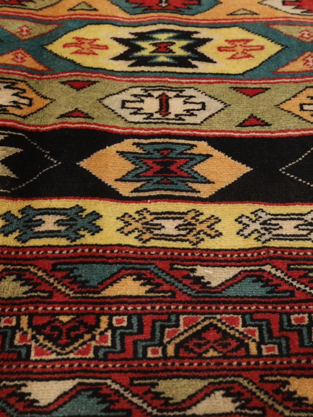 Hand-knotted Turkaman rug from the Middle East in vibrant red and geometric patterns