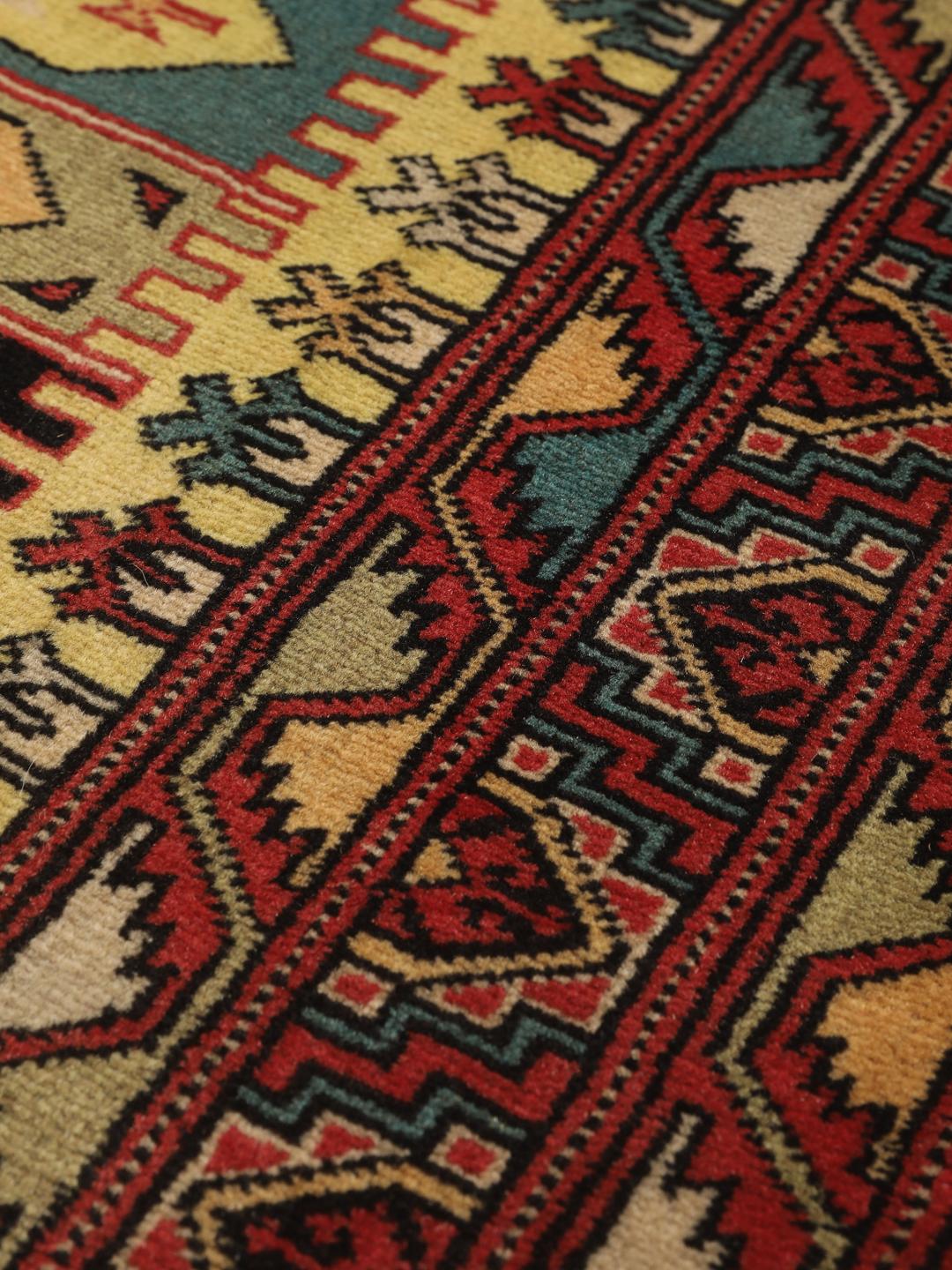 Hand-knotted Turkaman rug from the Middle East in vibrant red and geometric patterns