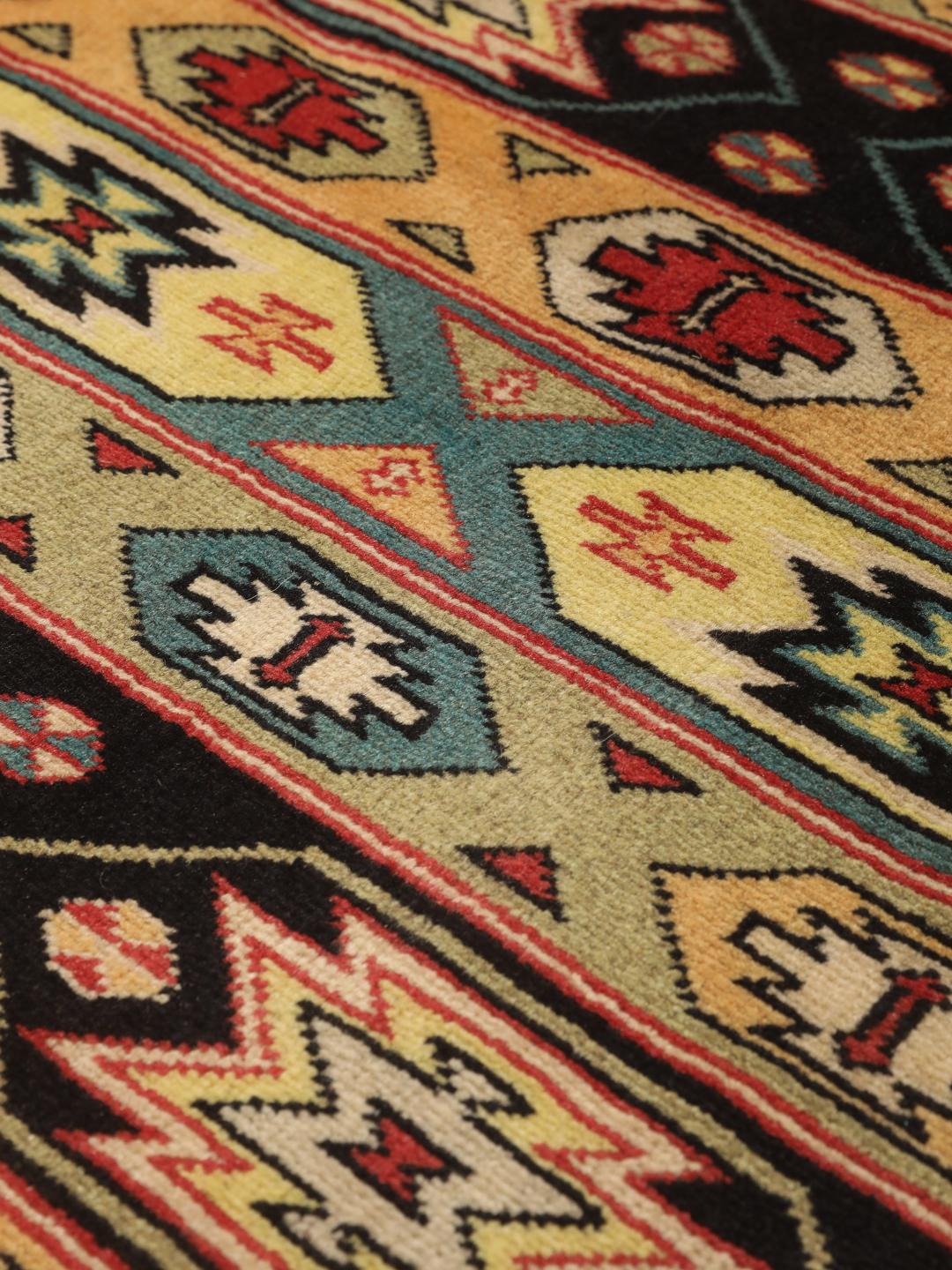 Hand-knotted Turkaman rug from the Middle East in vibrant red and geometric patterns