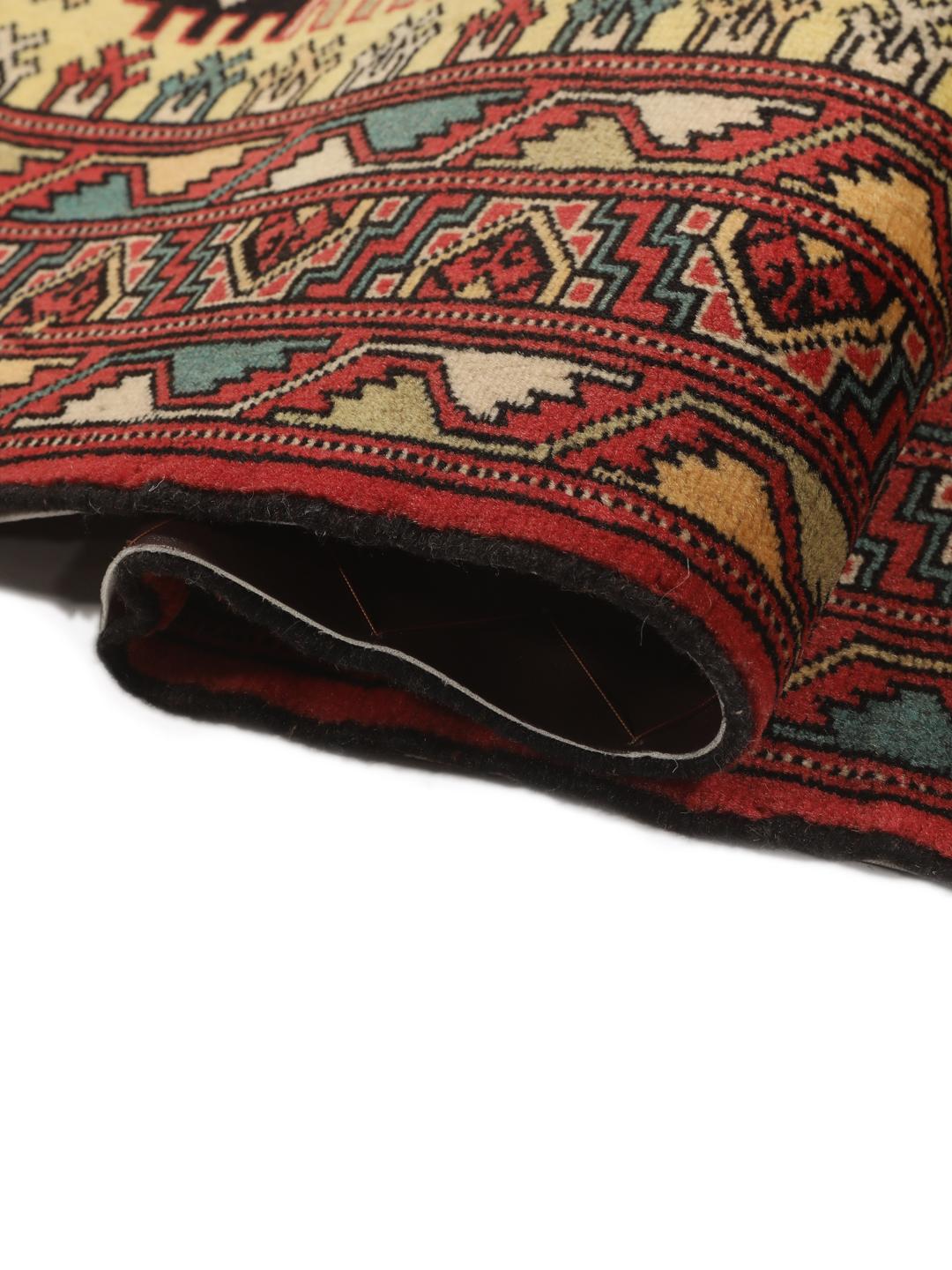 Hand-knotted Turkaman rug from the Middle East in vibrant red and geometric patterns