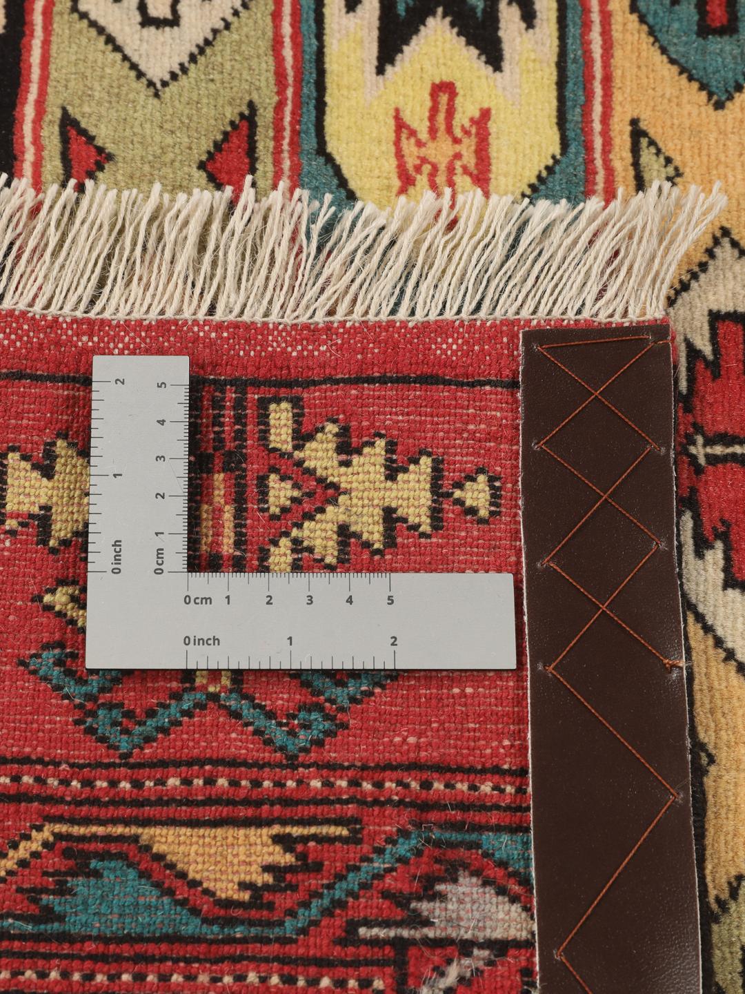 Hand-knotted Turkaman rug from the Middle East in vibrant red and geometric patterns