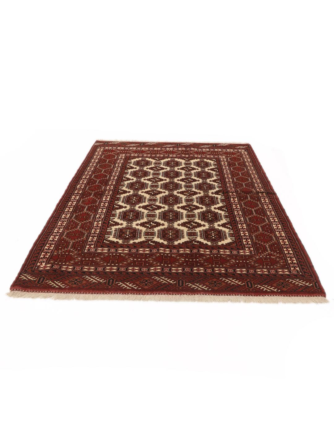 Hand-knotted Turkaman rug from the Middle East in deep red and cream tones.