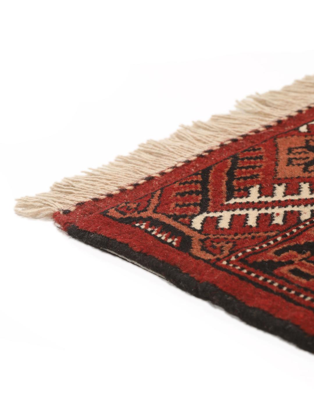 Hand-knotted Turkaman rug from the Middle East in deep red and cream tones.