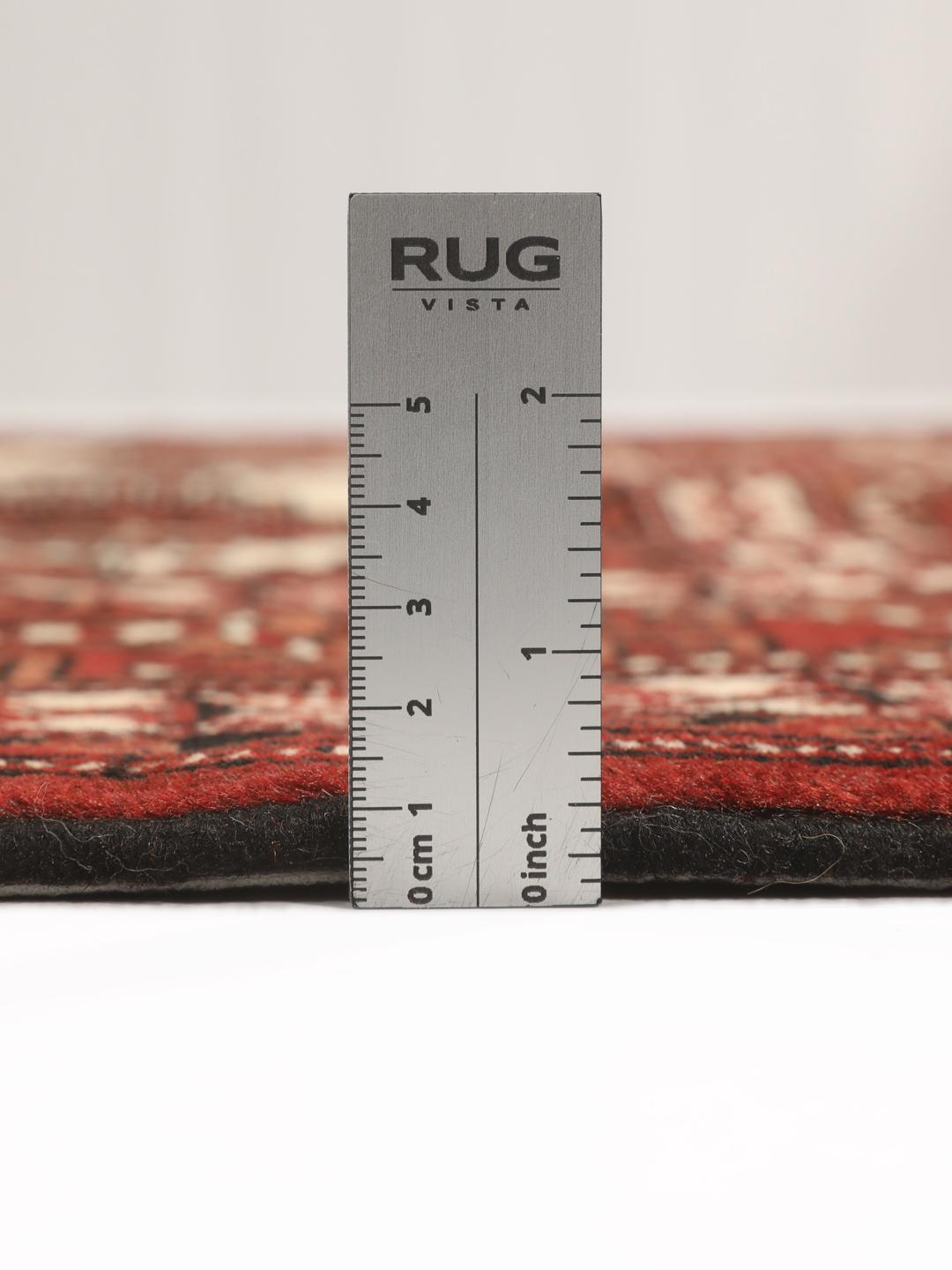 Hand-knotted Turkaman rug from the Middle East in deep red and cream tones.