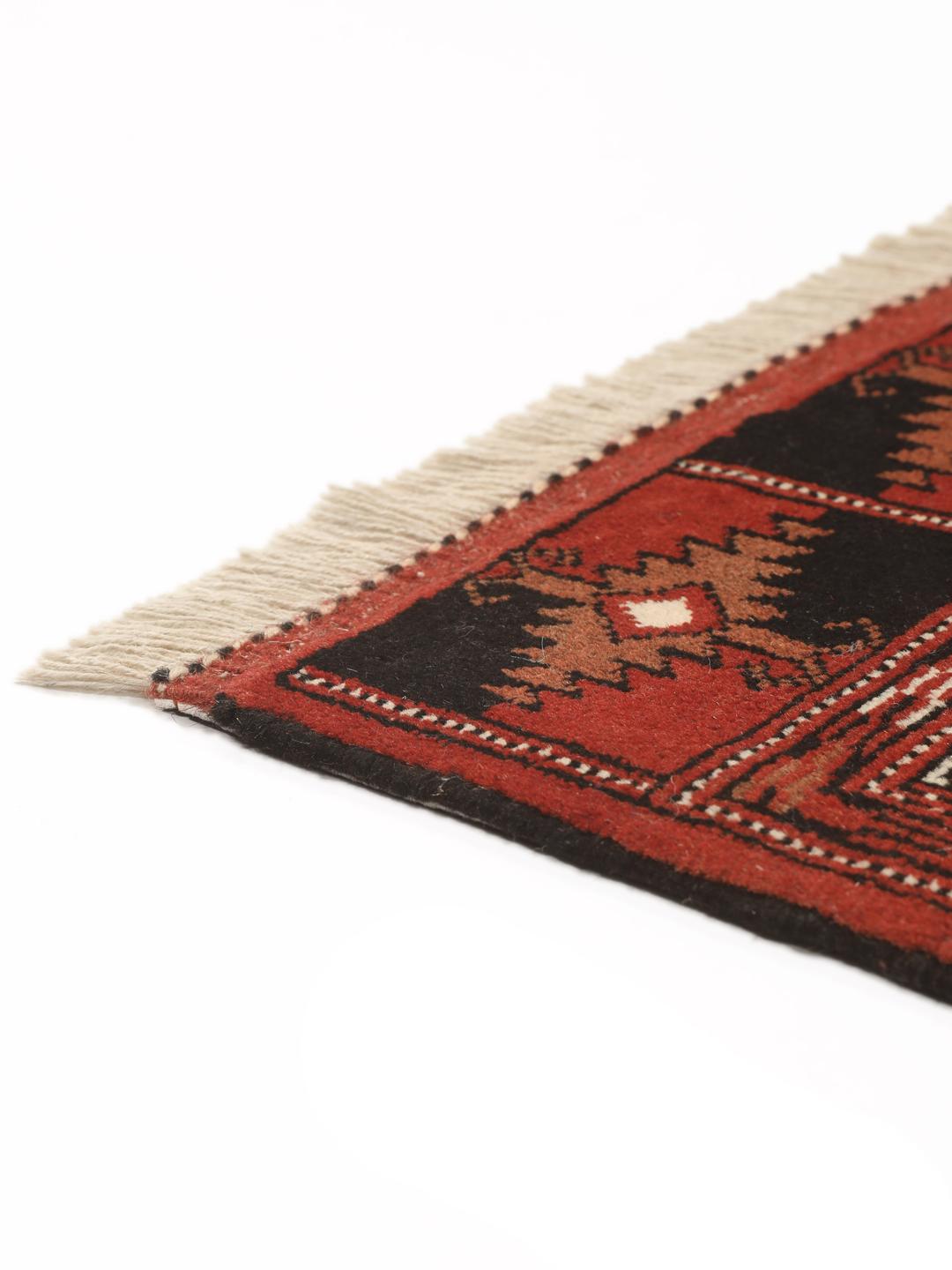 Hand-knotted Turkaman rug from the Middle East in deep red and beige tones.