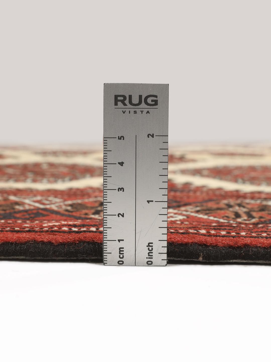 Hand-knotted Turkaman rug from the Middle East in deep red and beige tones.
