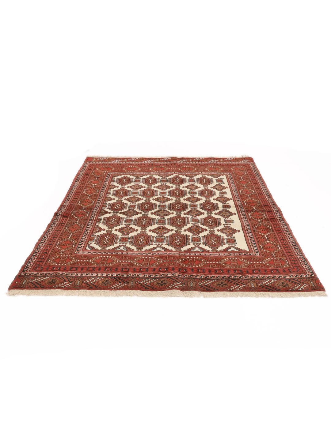 Hand-knotted Turkaman rug from the Middle East in red and beige tones.