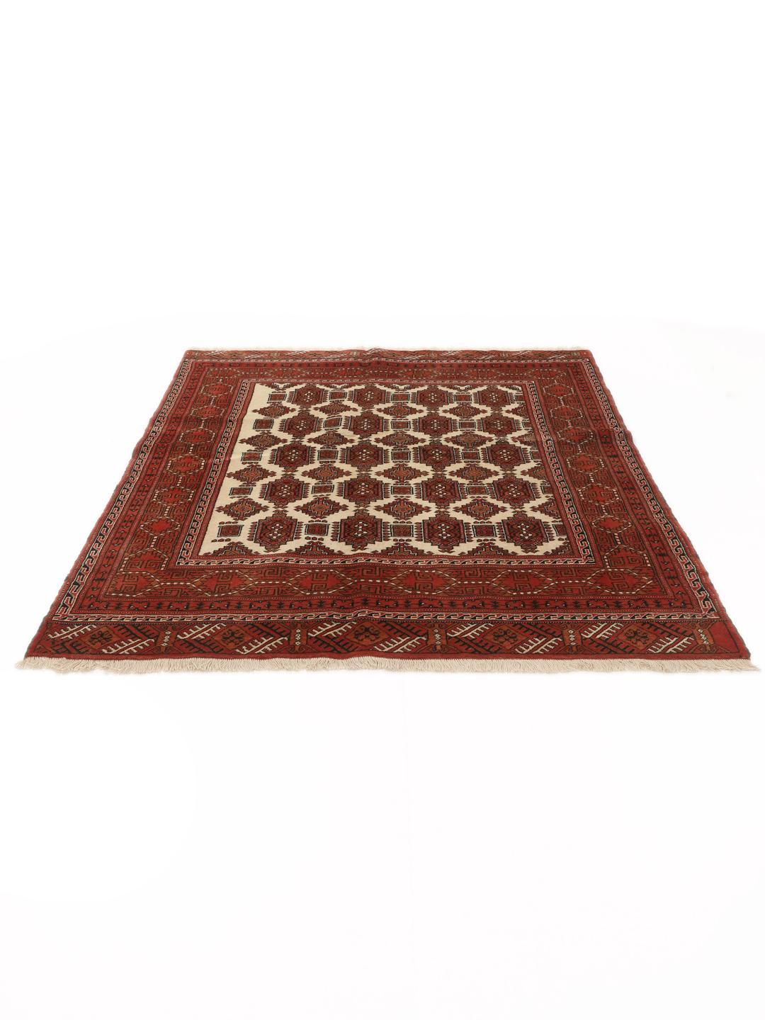 Hand-knotted Turkaman rug from the Middle East in red and beige tones.