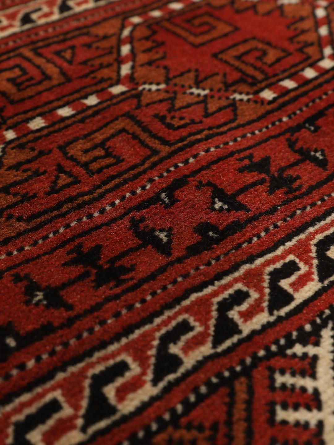 Hand-knotted Turkaman rug from the Middle East in red and beige tones.