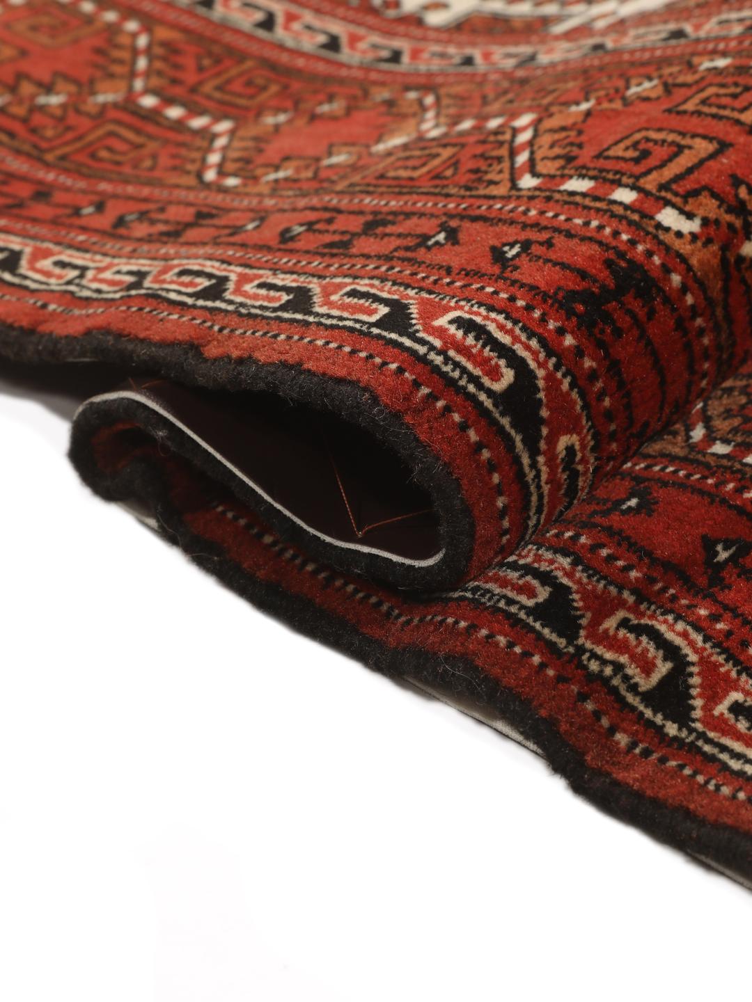 Hand-knotted Turkaman rug from the Middle East in red and beige tones.