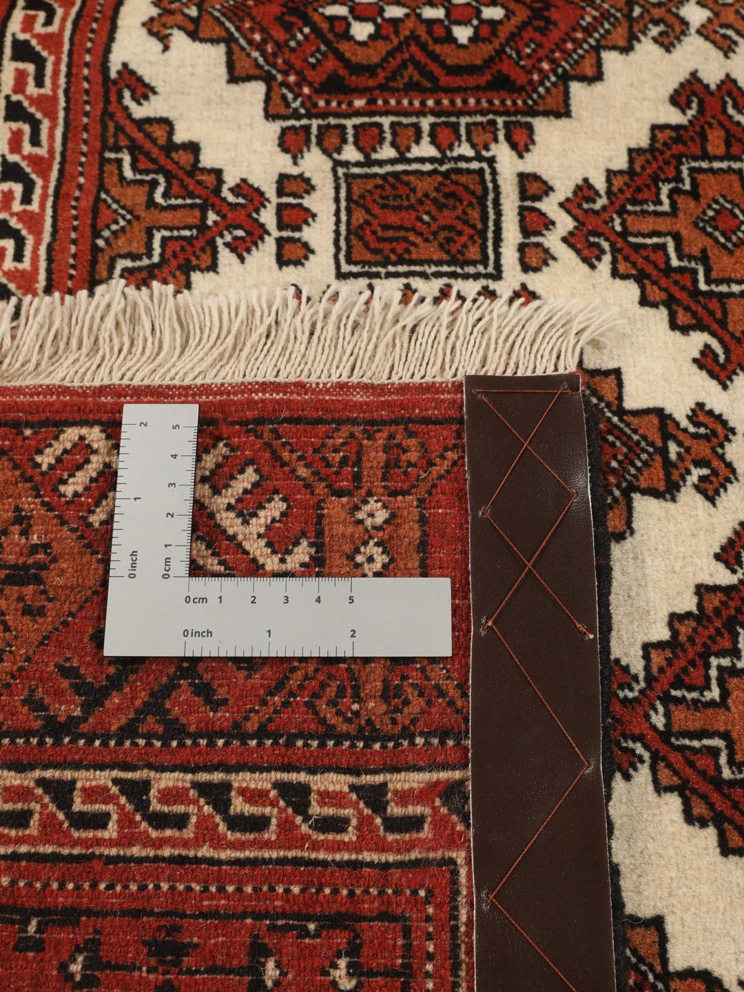 Hand-knotted Turkaman rug from the Middle East in red and beige tones.