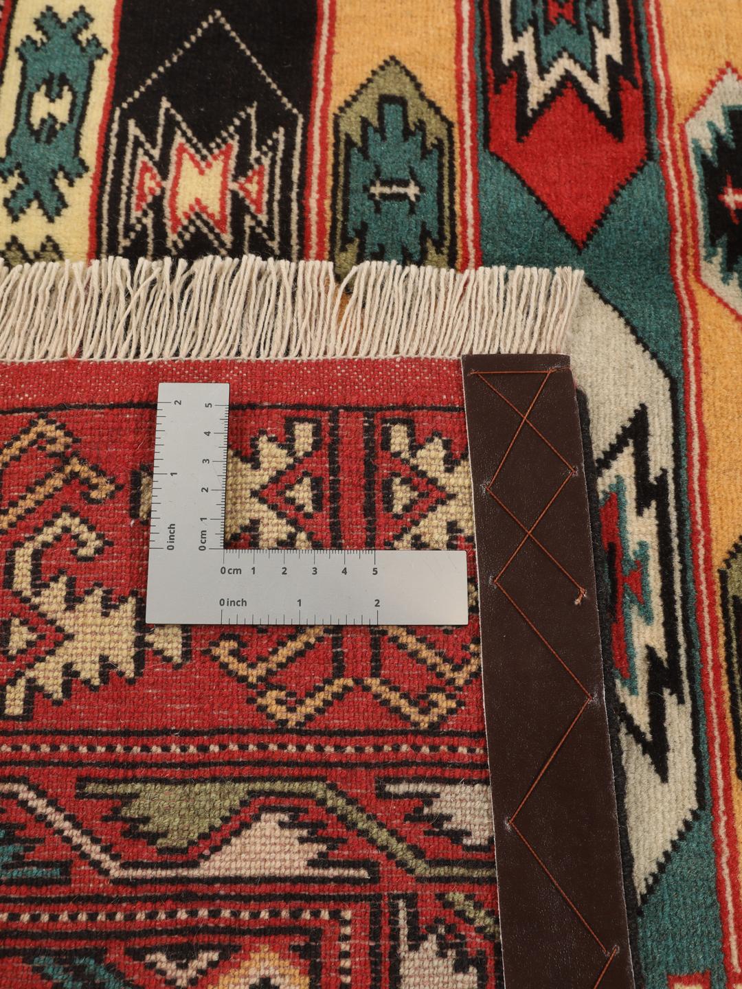 A hand-knotted Turkaman rug from the Middle East with a red base and geometric patterns.