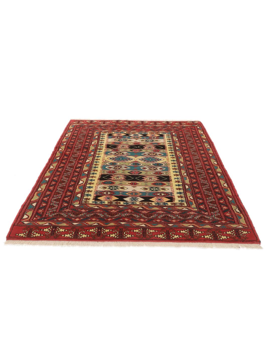 A hand-knotted Turkaman rug from the Middle East with a vibrant red and multicoloured geometric design.