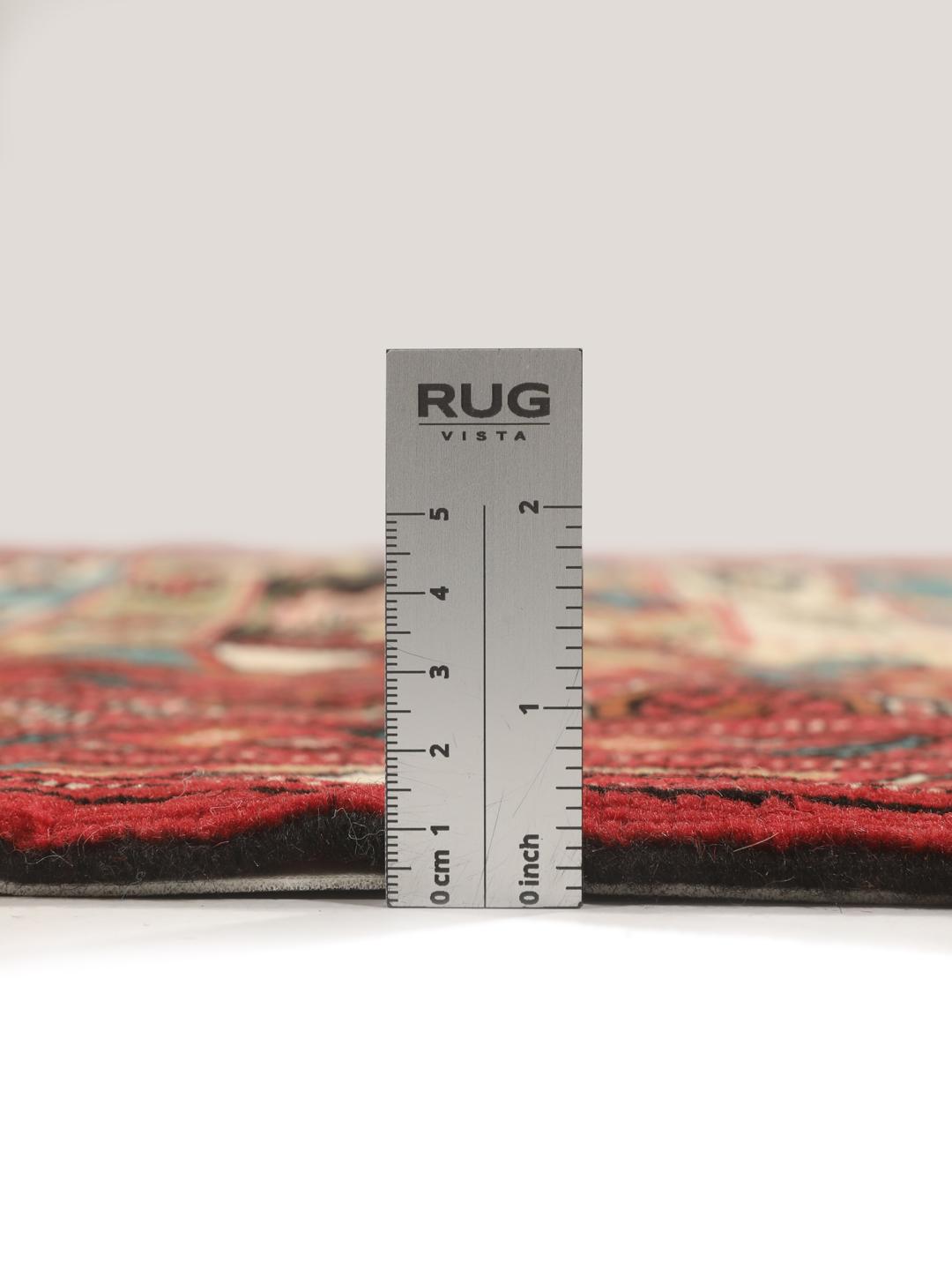 A hand-knotted Turkaman rug from the Middle East with a vibrant red and multicoloured geometric design.