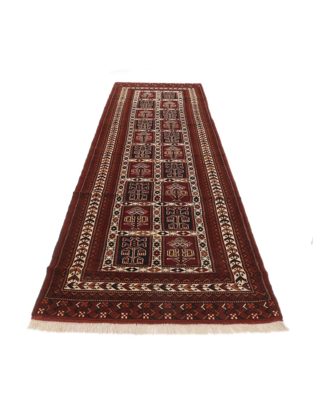 A hand-knotted Turkaman runner from the Middle East featuring a dark-red field with geometric motifs.