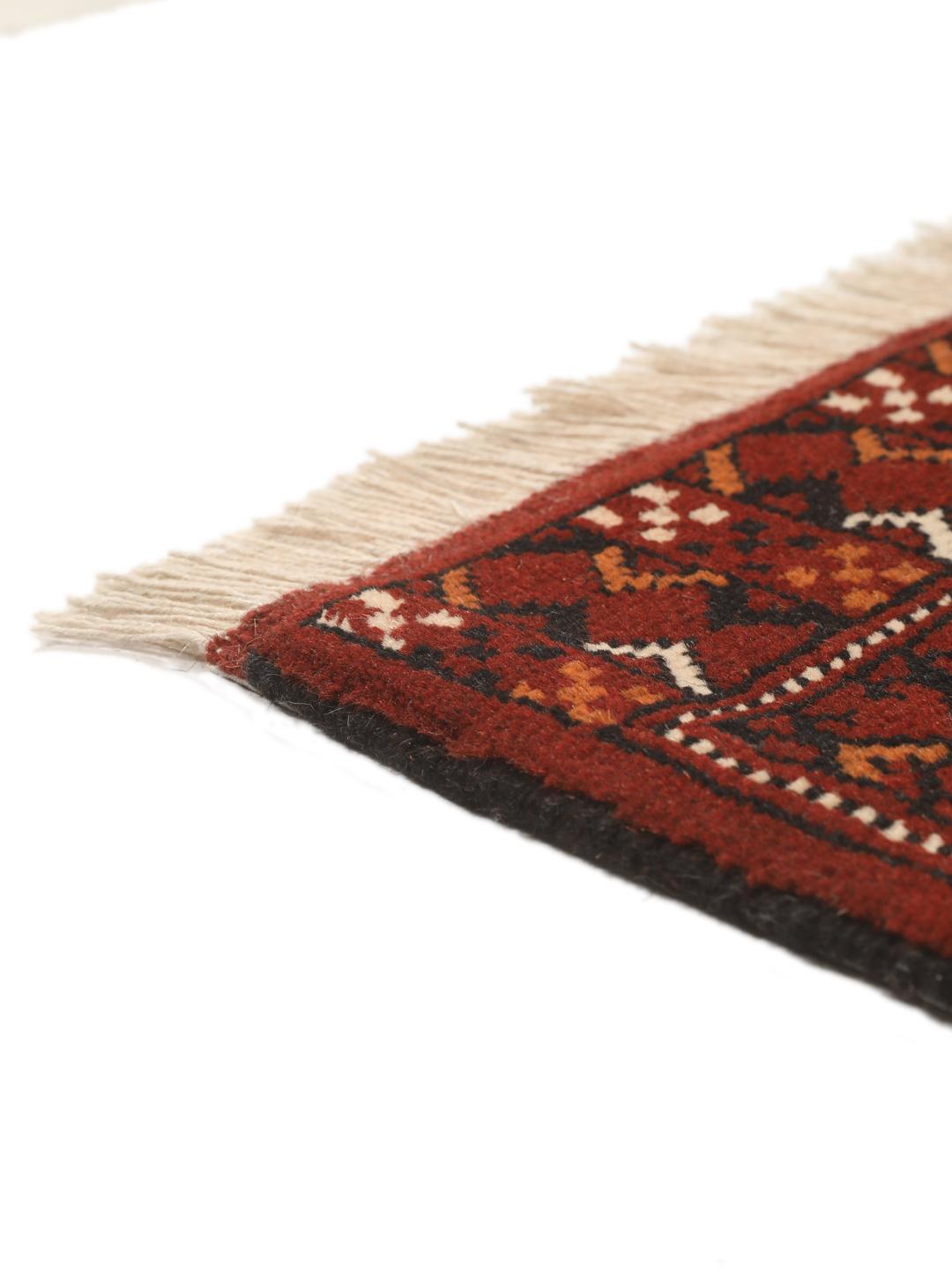 A hand-knotted Turkaman runner from the Middle East featuring a dark-red field with geometric motifs.