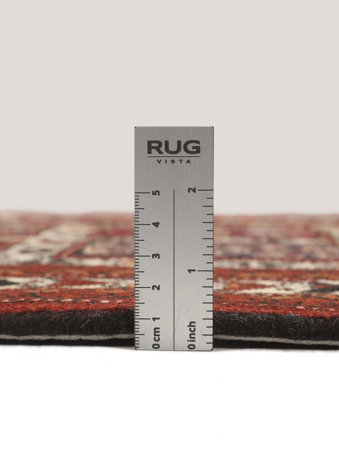 A hand-knotted Turkaman runner from the Middle East featuring a dark-red field with geometric motifs.