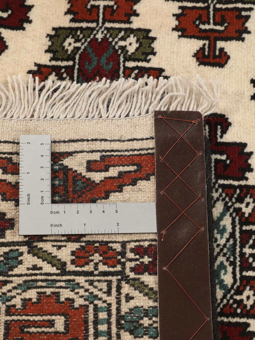 Hand-knotted Turkaman rug from the Middle East with a beige background and traditional geometric motifs.