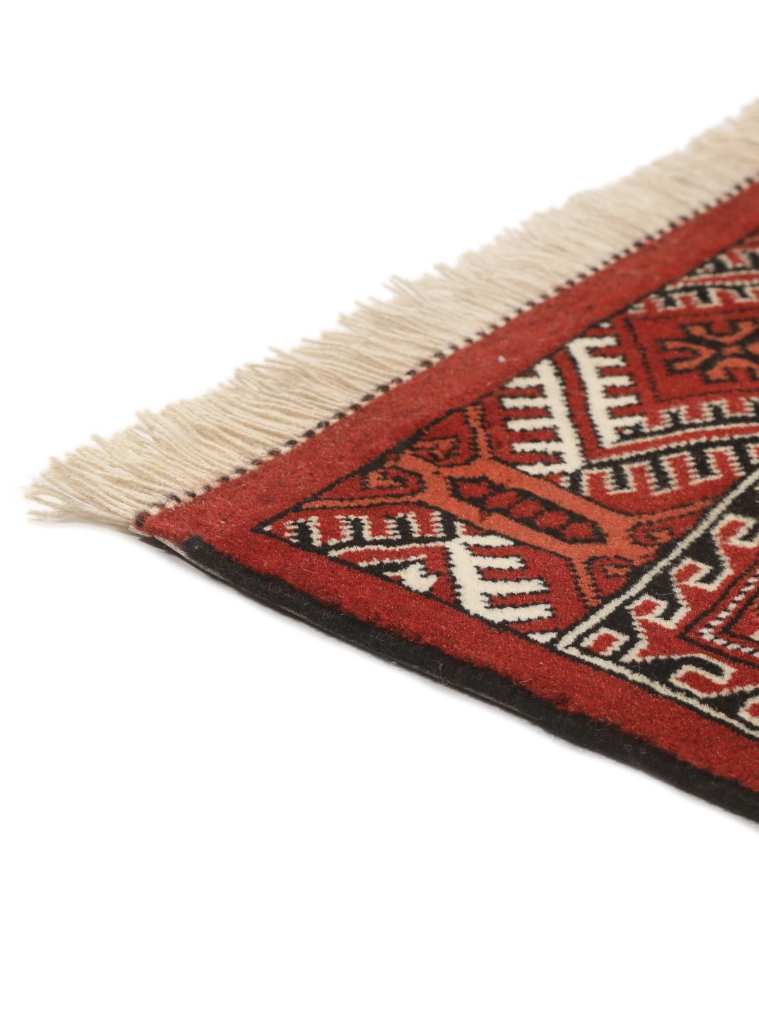 Hand-knotted Turkaman rug from the Middle East with a red and cream geometric design