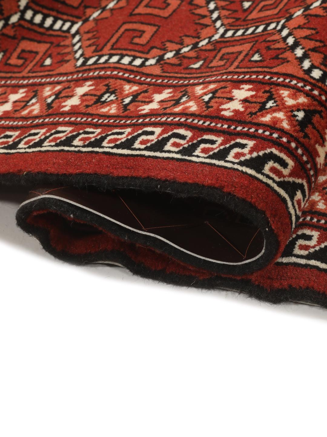 Hand-knotted Turkaman rug from the Middle East with a red and cream geometric design