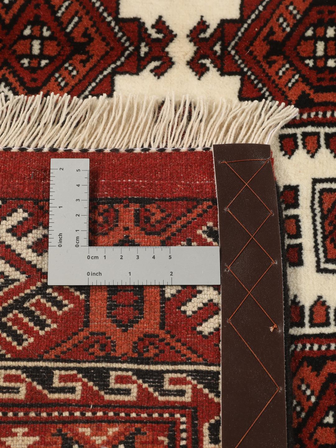 Hand-knotted Turkaman rug from the Middle East with a red and cream geometric design