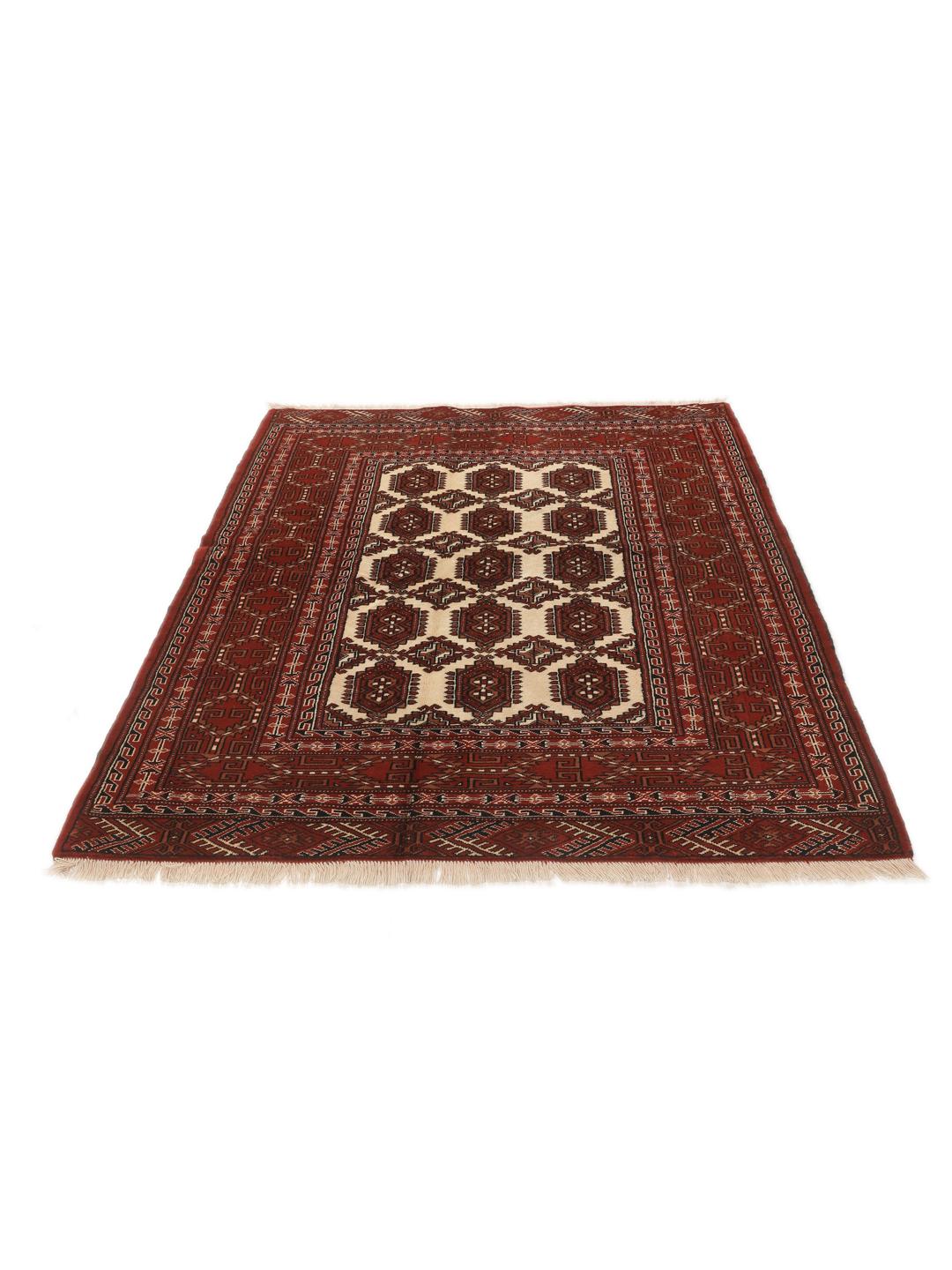 A hand-knotted Turkaman rug with a deep red field and traditional geometric motifs from the Middle East.