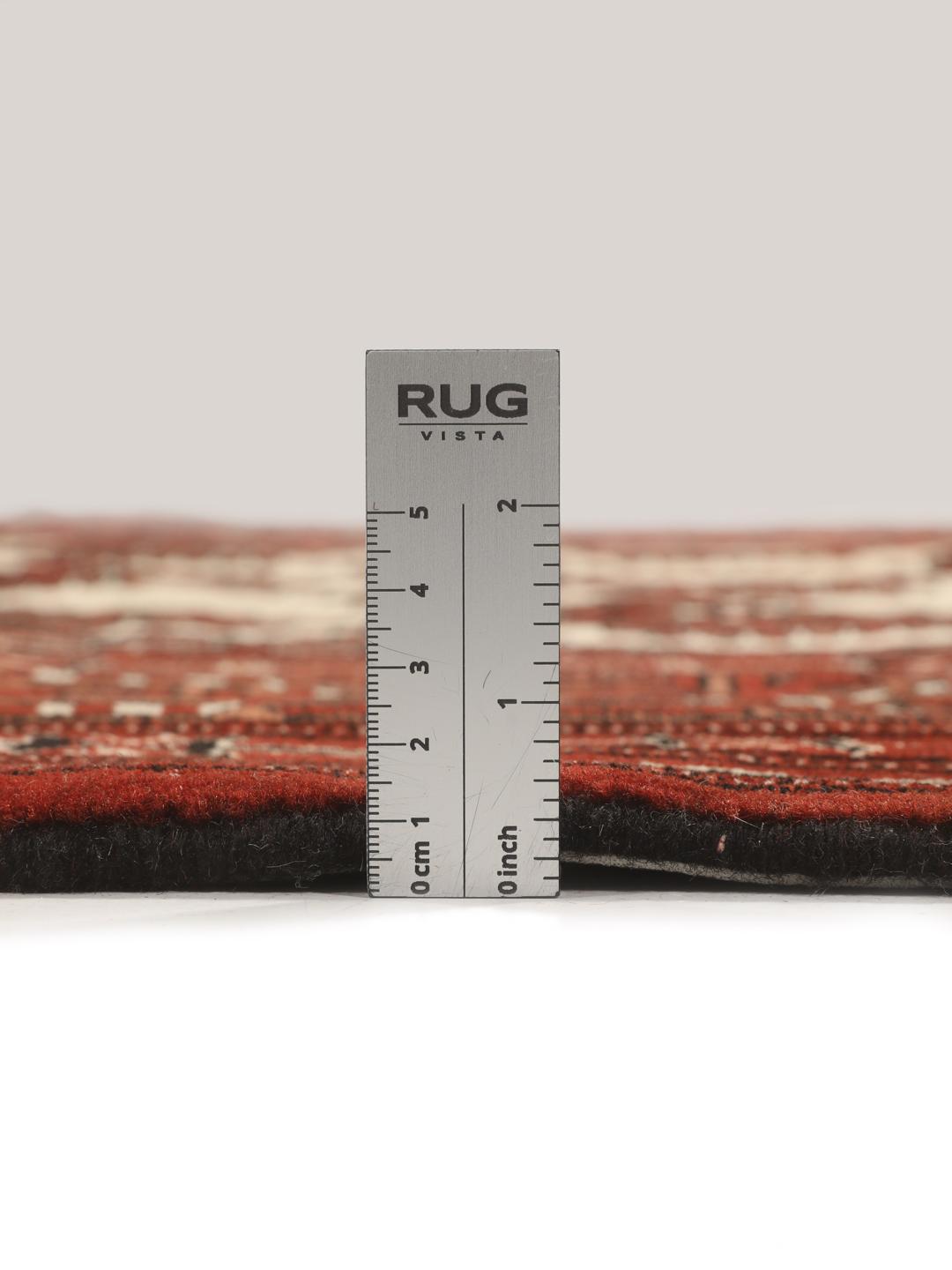 A hand-knotted Turkaman rug with a deep red field and traditional geometric motifs from the Middle East.