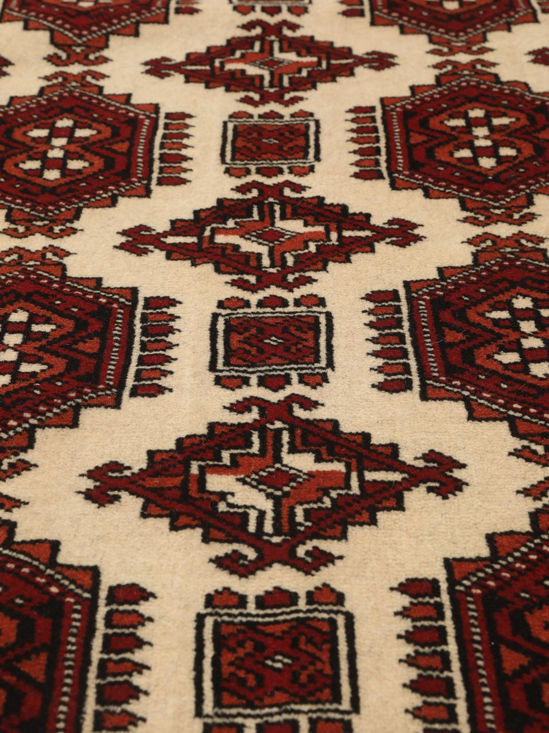 Hand-knotted Middle Eastern Turkaman rug in red and beige tones