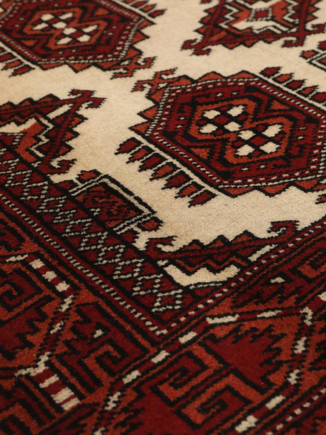 Hand-knotted Middle Eastern Turkaman rug in red and beige tones