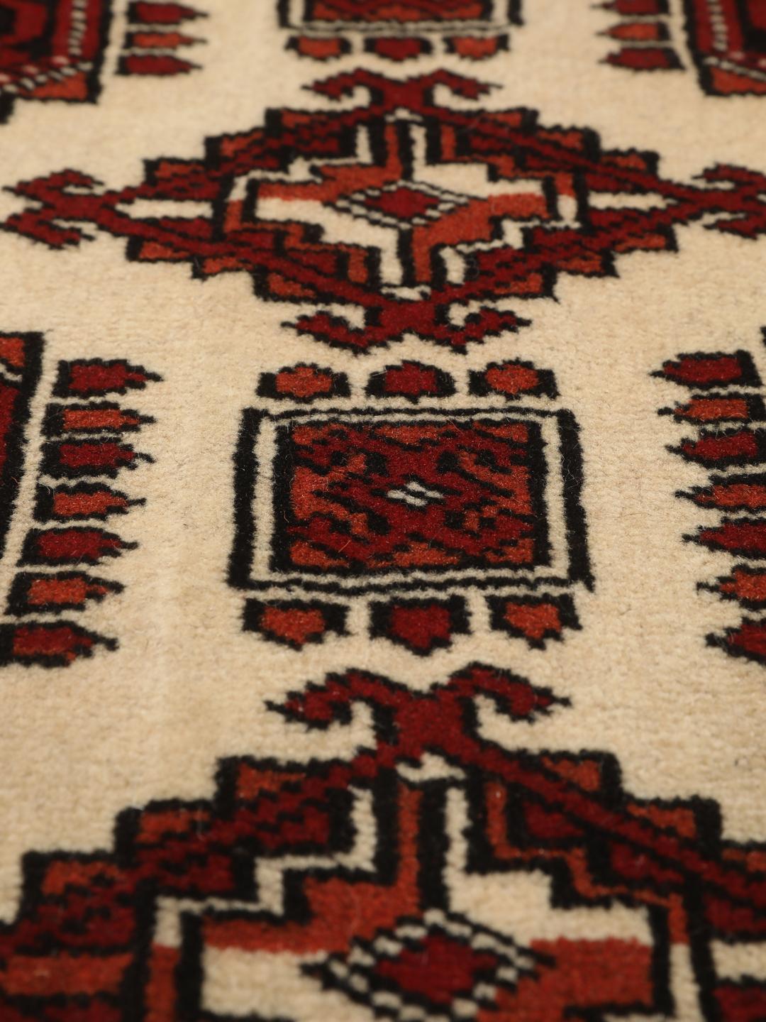 Hand-knotted Middle Eastern Turkaman rug in red and beige tones