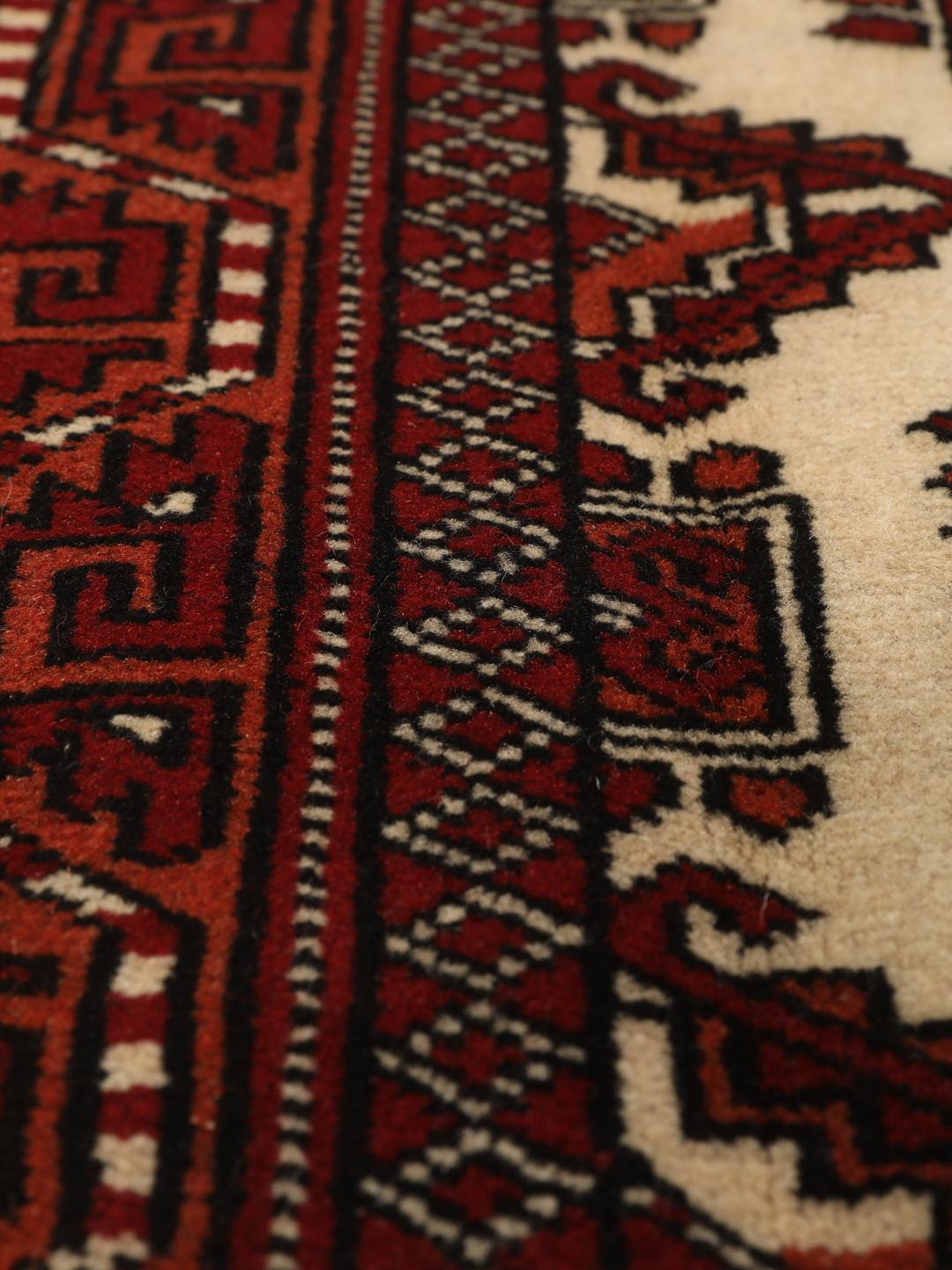 Hand-knotted Middle Eastern Turkaman rug in red and beige tones