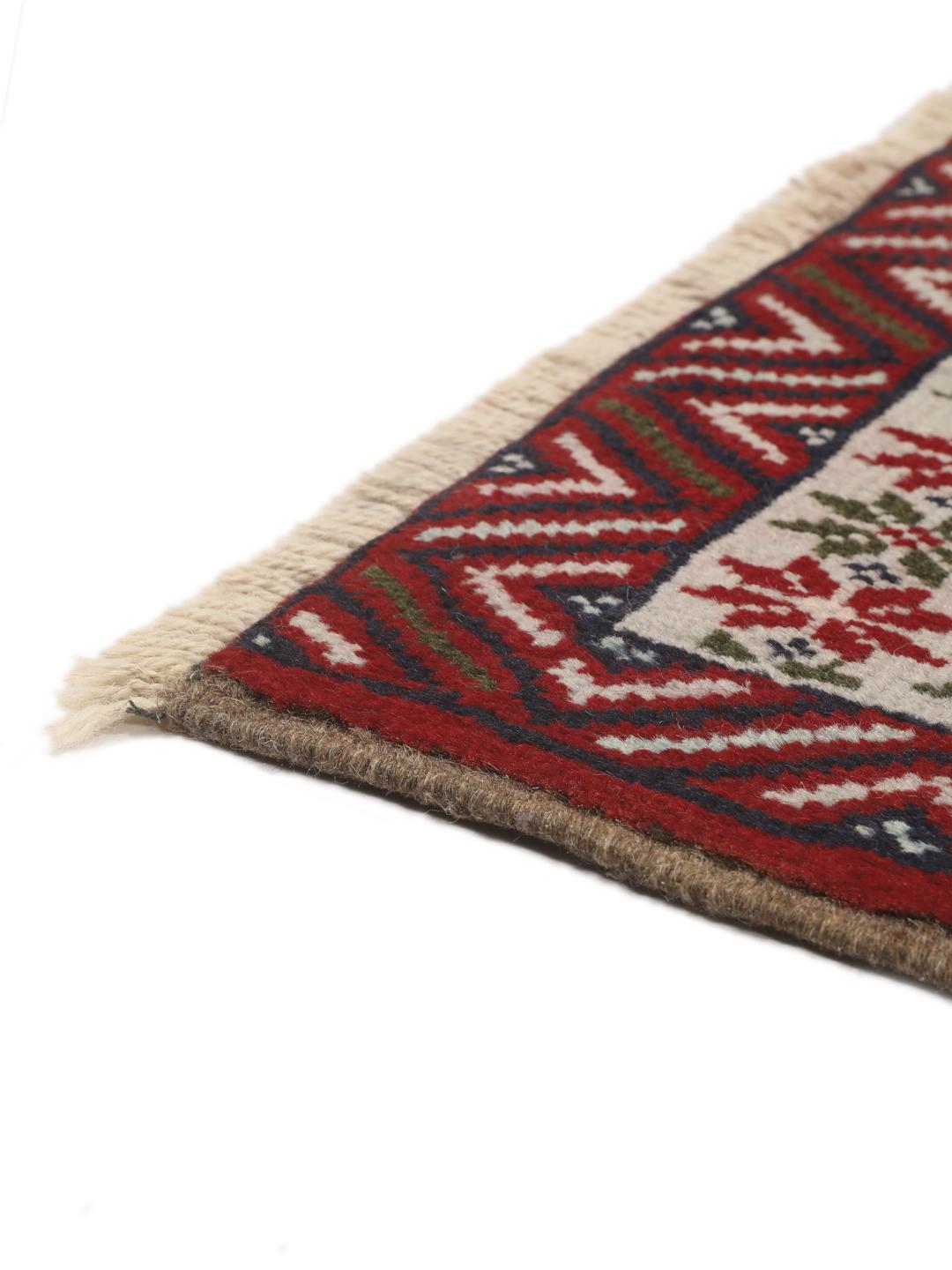 Hand-knotted Baluch rug with geometric motifs and red tones from the Middle East