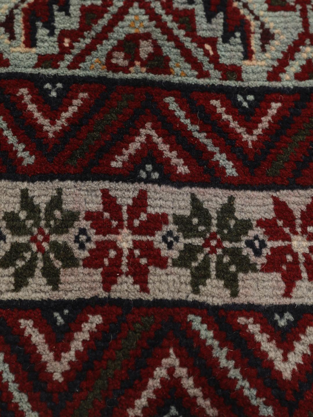 Hand-knotted Baluch rug with geometric motifs and red tones from the Middle East
