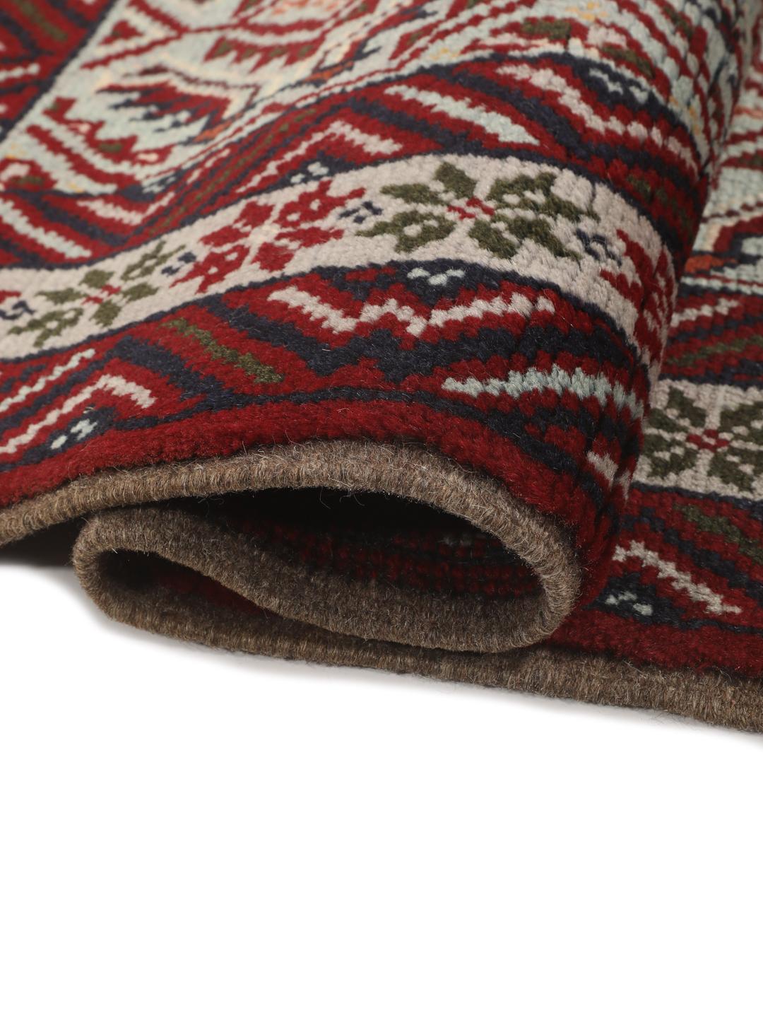 Hand-knotted Baluch rug with geometric motifs and red tones from the Middle East