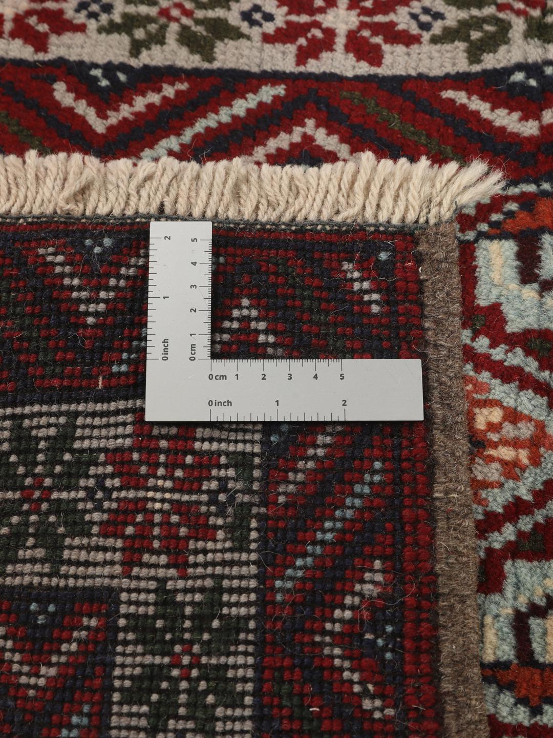 Hand-knotted Baluch rug with geometric motifs and red tones from the Middle East