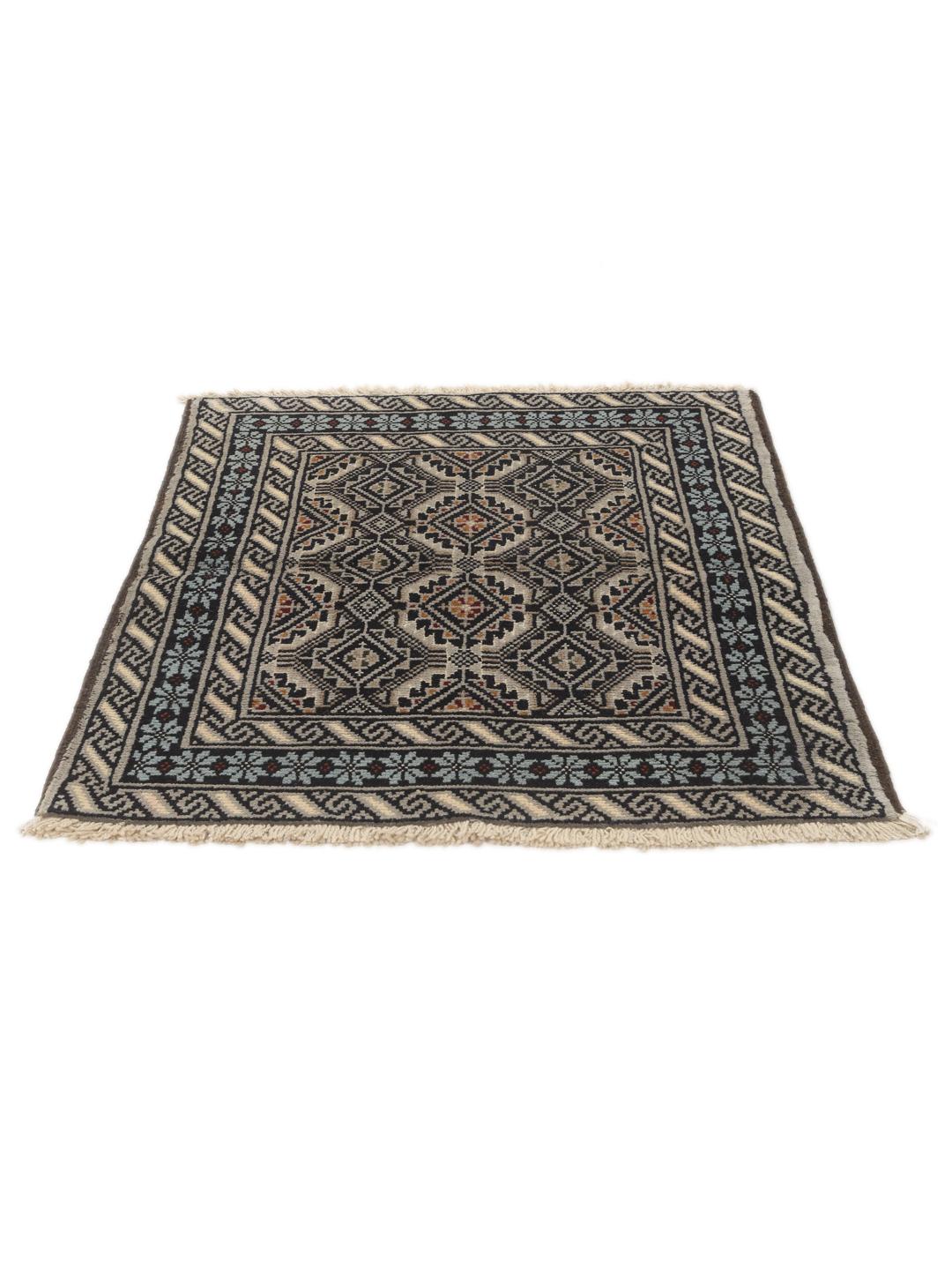 Hand-knotted Beluch rug from the Middle East in dark-blue and cream tones.