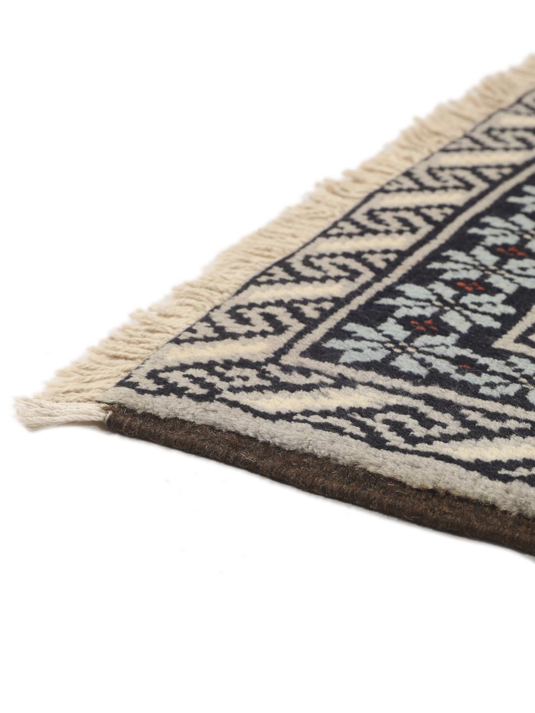 Hand-knotted Beluch rug from the Middle East in dark-blue and cream tones.