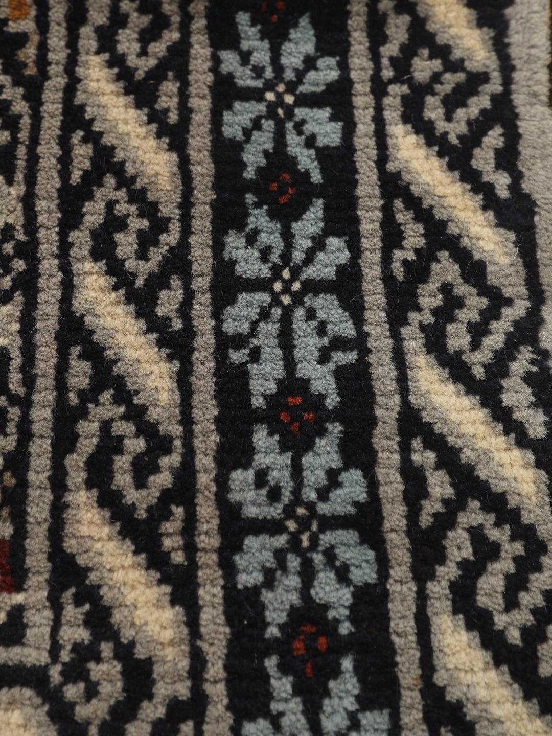 Hand-knotted Beluch rug from the Middle East in dark-blue and cream tones.