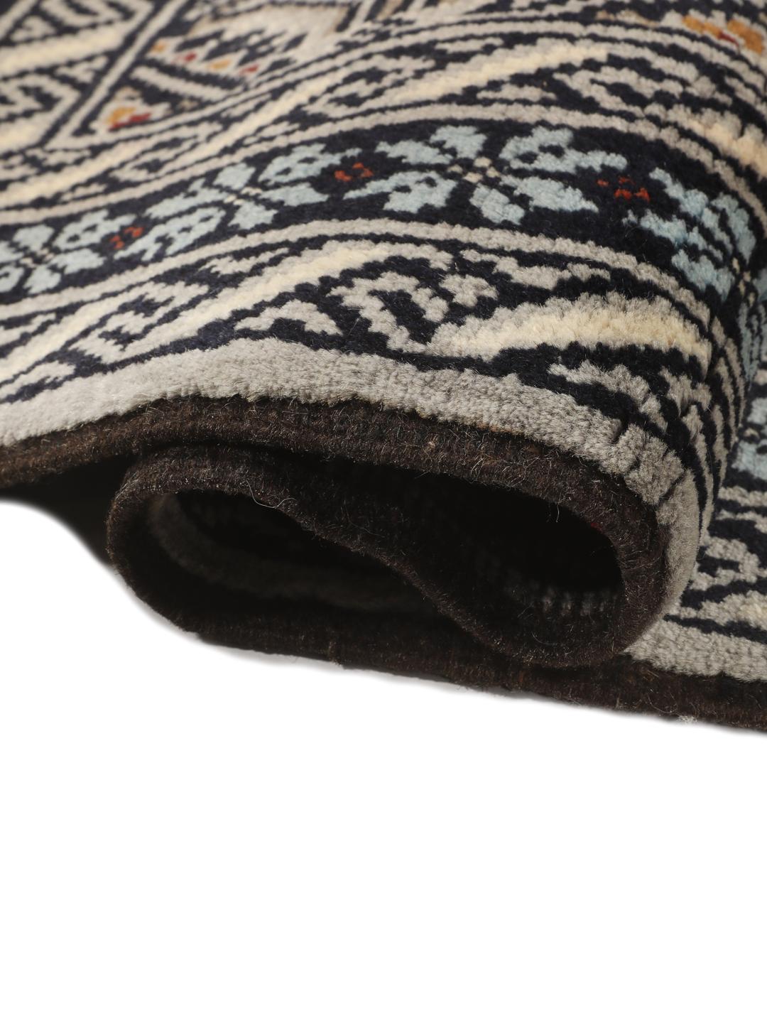 Hand-knotted Beluch rug from the Middle East in dark-blue and cream tones.