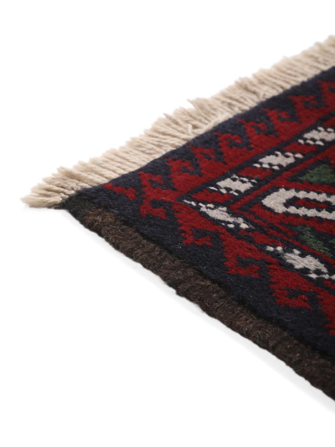 Handmade Baluch rug from the Middle East in dark blue and red tones.