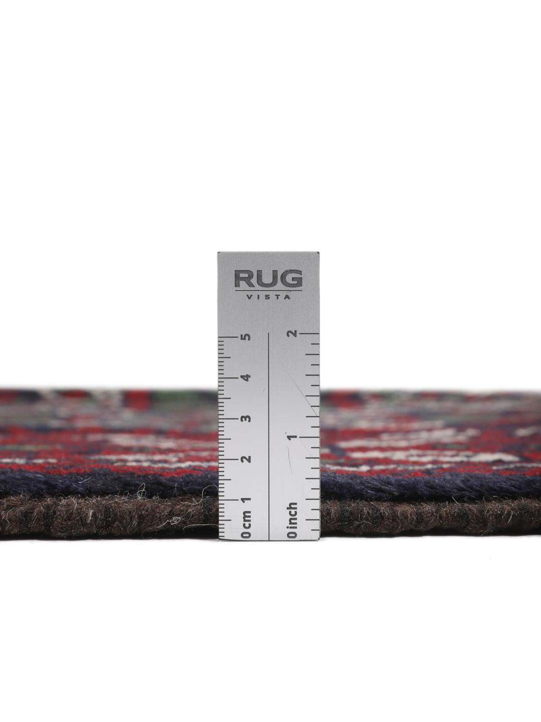 Handmade Baluch rug from the Middle East in dark blue and red tones.
